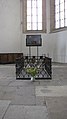 The grave in the south aisle; Cranach's Fourteen Holy Helpers can be seen behind the grave