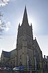 A stone church dominated by a large, tall steeple