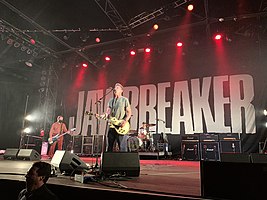 Jawbreaker performing at Fillmore Auditorium in Denver, April 2022. Left to right: Bauermeister, Schwarzenbach, and Pfahler.