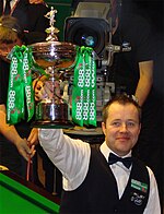 John Higgins holding a trophy