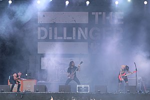 The Dillinger Escape Plan at With Full Force 2014. From left to right: Greg Puciato, Billy Rymer behind Liam Wilson, and James Love (Ben Weinman not shown).