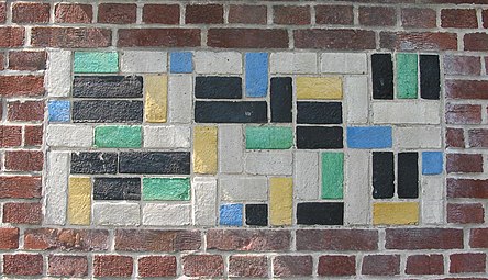 De Stijl - Panel of polychrome bricks on the exterior of the Vakantiehuis De Vonk [nl], a house in Noordwijkerhout, the Netherlands, by Theo van Doesburg, 1917-1919[74]