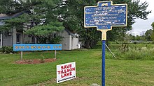 a picture of the marker with the house behind it