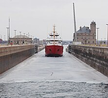 CCGS Samuel Risley starts the shipping season by breaking the ice in the Poe Lock