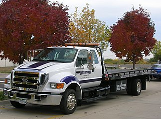 A Ford F-650 flatbed tow truck