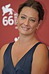 Giovanna Mezzogiorno at 2009 Venice Film Festival, wearing a dark blue dress and smiling