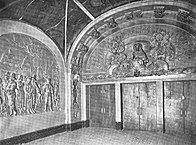 Black-and-white picture of the foyer to the auditorium. There is an arched mural above the doors.