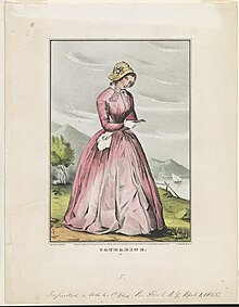 19th century picture of a lady with a pink dress, white skin, and brown hair covered by a bonnet, standing on a brown and green soil with green valleys and water visible in the background.