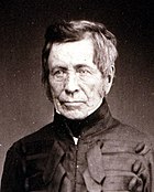 Early black and white photograph of an older man in a military uniform.