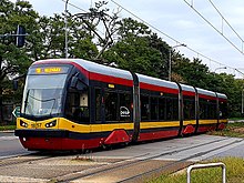 Tram in red grey and yellow horizontally striped livery