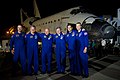 The crew pose for a photo on the runway after landing.