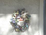 A funeral wreath on the door of apartment 132A.