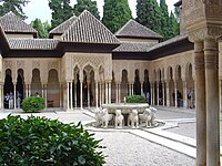 Court of the Lions in 2003, before most recent restoration. Most of the floor was occupied by beds of gravel. The domed roof and the fountain upper sections were removed in the 20th century.