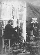 Photograph of Dagnan at his easel while his wife Walter poses in Breton costume. Taken in 1886