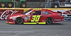 Inception Motorsports' red No. 30 Chevrolet on track at Charlotte Motor Speedway