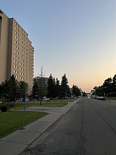 A street in Empire Park, Edmonton, featuring the Viking Arms apartment building, highlighting the high-density nature of the neighbourhood.