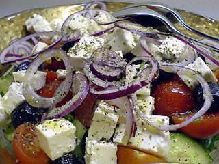 Greek salad as served in other countries. The main differences are the serving of the feta cheese in multiple cube-shaped cuttings instead of a single rectangular-piece and the more liberal supply of onion.