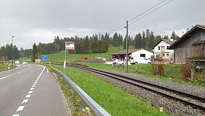 Posted sign located between railway track and roadway