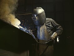 A welder making the boilers for ship, 1942.