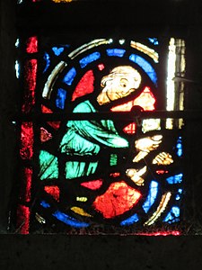 Detail of the Window of the Passion; a butcher, sponsors of the window, at work (13th c.)