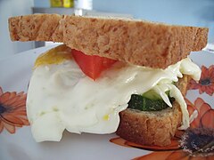Sandwich with fried egg, tomato and cucumber