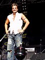 English-Australian singer Peter Andre in 2004 wearing ripped and sandblasted baggy jeans influenced by surfer and hip-hop fashion.