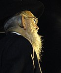 Religious Jew with beard and payot tucked behind ear
