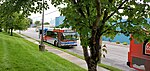 A gray, red and blue bus