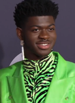 Lil Nas X, a Black man, wearing a green suit.