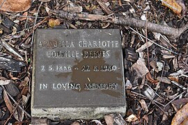 Photograph of a square metal grave marker bearing the name 'Arabella Charlotte Colville-Reeves Arabella Scott