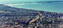 Bird's-eye view photo of Berdiansk, showing the industrial and residential areas and the adjacent Sea of Azov