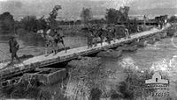 Camels being led across pontoon bridge