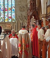 Fellow bishops prepare to lay hands on Bishop Vanessa and pray for her. On the left is Bishop Sarah Macneil and further right is Bishop Genieve Blackwell.