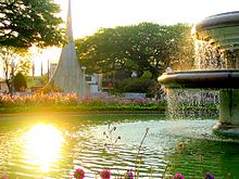 Fountain in Barão de Araras Square with the 100th Anniversary City Monument at the back