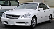 A Toyota Crown with warning lights in the front grill and "TA" antennas on the left and right sides of the rear window