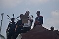 A middle-class worker calling for the office workers of SCBD to protest together.[237] He holds the sign, "Even Soeharto got scared! #WeDeserveBetter"