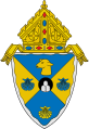 The arms of the Diocese of Rockville Centre: The mounds in the circle at the center of the arms are a play on the name of city in which the diocese is based, Rockville Centre, New York.[8]