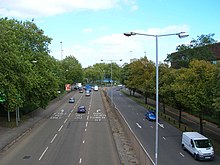 View of both carriageways, street lights and lane markings, on the approach to the junction 1 roundabout