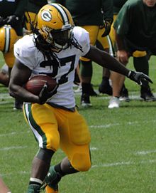 Lacy in uniform rushing the football