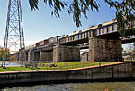 An old railway bridge on stone pillars.