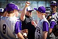 The SMH varsity baseball team takes a moment to huddle with their head coach during an inning break.