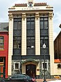 Sort of like a pediment, with an Elk head, a contributing building in St. Charles Historic District, i guess not --doncram (Here, the elk head is a sculpture)