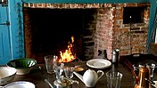 Kitchen fireplace and oven in use.