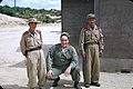 A US soldier poses with North Korean soldiers in this Kodachrome slide from 1956