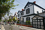 A row of non-Japanese looking wooden houses along a street.