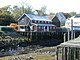 View of several wooden buildings at Seal Cove at low tide