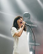 A picture of Lauren Mayberry, lead of singer of Chvrches on stage.