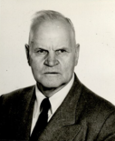 A close-up portrait photograph of Charles Redd