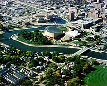 Aerial view of buildings, parkland and the river in downtown Rochester