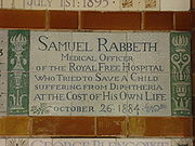 A tablet formed of six standard sized tiles, bordered by green flowers in the style of the Arts and Crafts movement